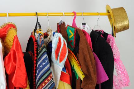 colorful costumes hang on a rack