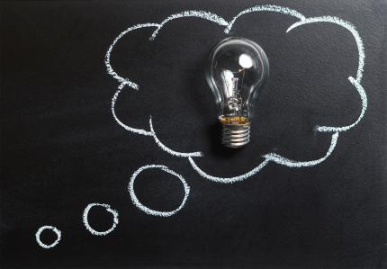 A thought bubble is drawn around a light bulb on a chalkboard.