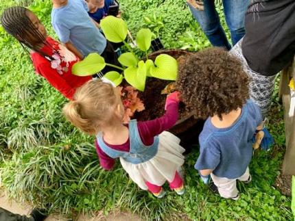 The Gardening for Kids program at Falls of Schuykill Library A group of kids outdoors standing around a plant
