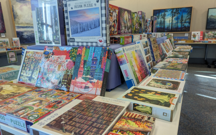 Photograph of tables set up with boxes of puzzles