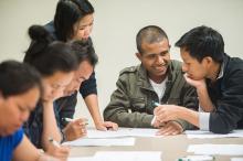 Experts from ASIA Inc. teach financial literacy to a Nepali-speaking man.