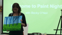 Becky O'Neil talks about her painting at the beginning of the event