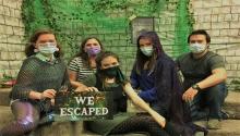 Photo of masked group in the escape room.