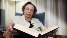 older woman reading a book