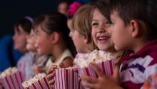 kids watching a movie with popcorn kids watching a movie with popcorn