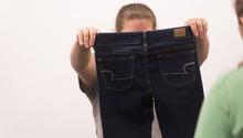woman holding jeans