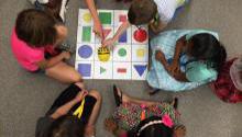 Children playing game on the floor Monster Maker