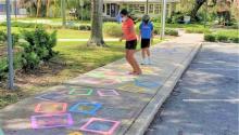Kids jumping through the sidewalk obstacle course.