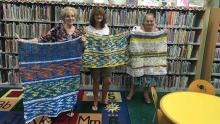 Helping Hands: Upcycling With Dual Purposes Three women holding up mats