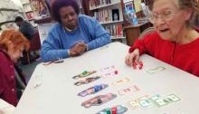 Enjoying a game from the Circulating Board Game Collection Women playing a game
