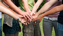 Teens with hands in a circle
