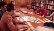 Fridays Before Finals Students playing a board game in the library