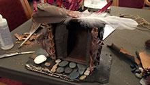 Fairy house created from slate, feathers and pinecones Fairy house created from slate, feathers and pinecones