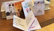 Photograph of the tiny books, one open to reveal the pages.