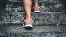 Photo of someone walking up stairs; zoomed in on sneakers.