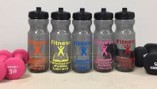 five water bottles and two sets of dumbbells