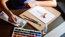To-Go Crafts Photo of a person painting in watercolor.