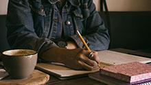 Publishing Writer’s Support Group Woman writing in notebook