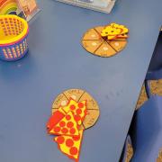  Photograph of a Manipulation Station table with paper pizza puzzles