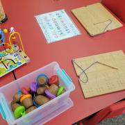 Photograph of a Manipulation Station table with paper and craft supplies