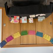 Photograph of a finished papel picado hung above a display table