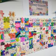 Photograph of the Tomahawk Public Library Community Puzzle on the wall