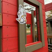 Illustration of Bigfoot taped to playground equipment