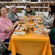 A table of participants work on their charcuterie