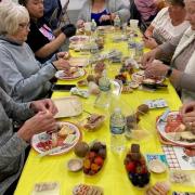 A table of participants work on their charcuterie