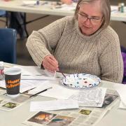 Participant painting on canvas