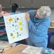 A program participant displays finished flower dye