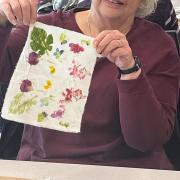 A program participant displays finished flower dye