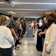 Regency Dance Class participants in a large room dancing