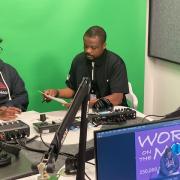 People recording the World on the Move podcast in a recording studio in front of a green screen