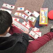 A child plays with color cards