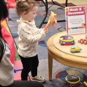 A child plays with musical instruments