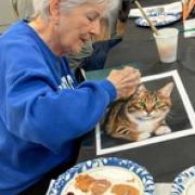 Person painting a cat portrait
