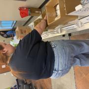 A photograph of a person putting together an emergency kit