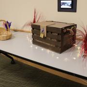 Photograph of a table with a box and other puzzle elements