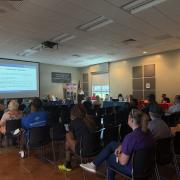 A photograph of a full room watching a presentation on emergency preparedness