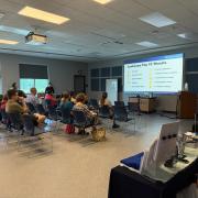 A photograph of a full room watching a presentation on emergency preparedness
