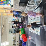 Babies and their caregivers dance around the Baby Rave room