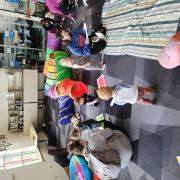 Babies and their caregivers dance around the Baby Rave room