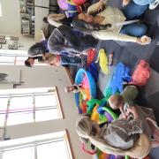 Babies and their caregivers dance around the Baby Rave room