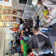 Babies and their caregivers dance around the Baby Rave room