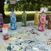 Various tie dye bottles on an outdoor table