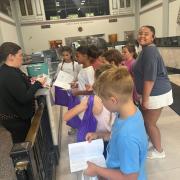 A group of students getting their passport pamphlets