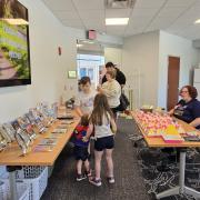 Pokemon Community Day room set-up with books and materials set out on tables.
