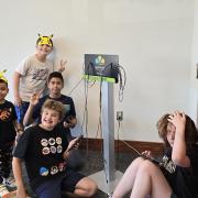 Participants pose in front of a charging station