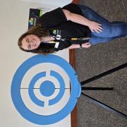 A person posing with a Pokemon Go symbol